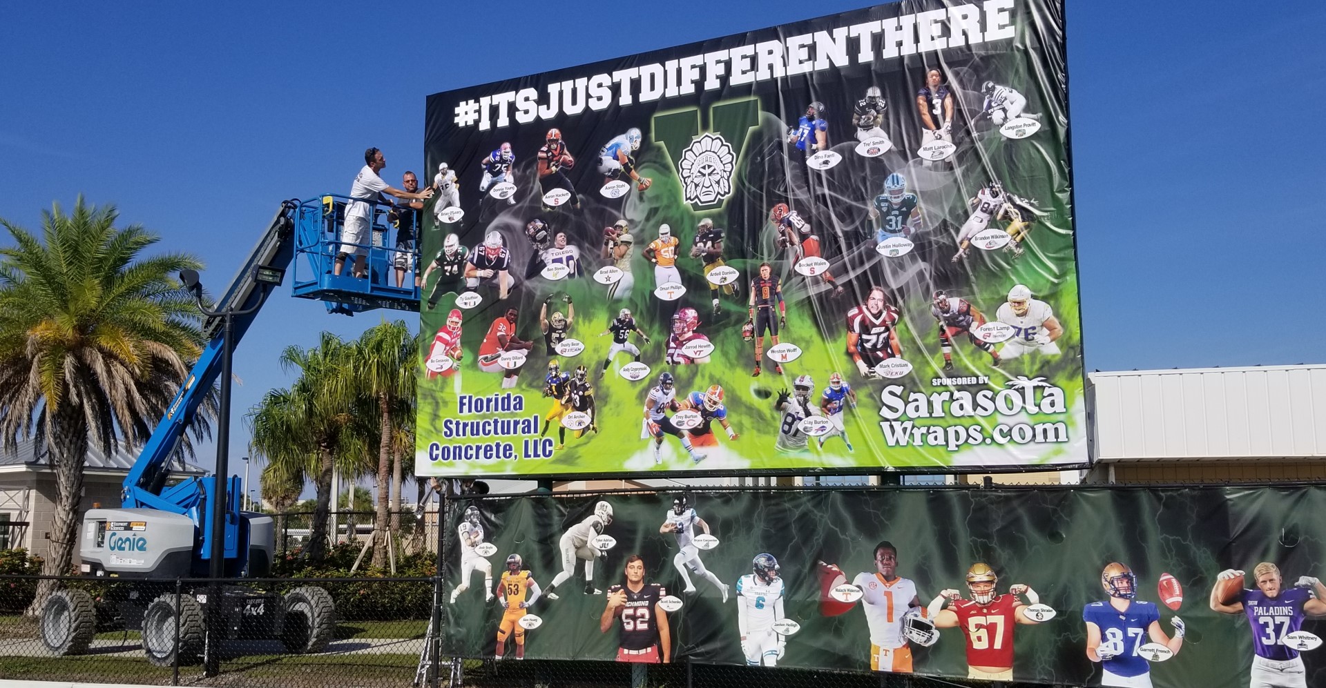 Crew installing a large printed banner